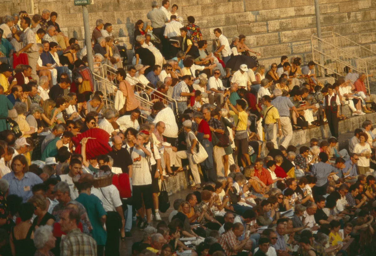 The audience gathered on the stone steps of the Arena di Verona before a performance